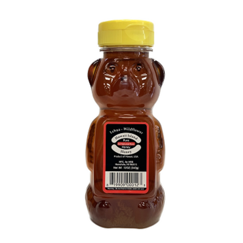 Honey bear container with yellow lid on a white background