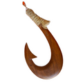 Wooden fish hook with gold wrapping on a white background
