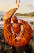 carved wooden fish hook with honu