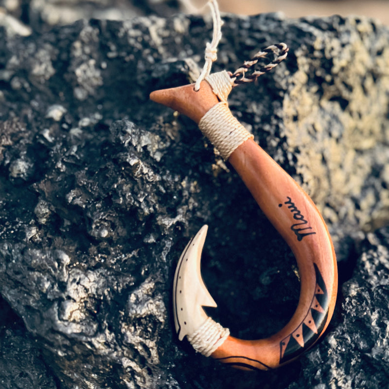 Fishhook that has Maui written on it.