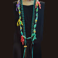 Colorful braided necklace on a black background