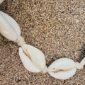 Shell bracelet on a sandy surface