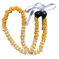Yellow and white mongo shell lei with brown kukui nuts on the end tied with a ribbon.