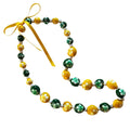 Necklace with green, yellow, and white beads on a white background