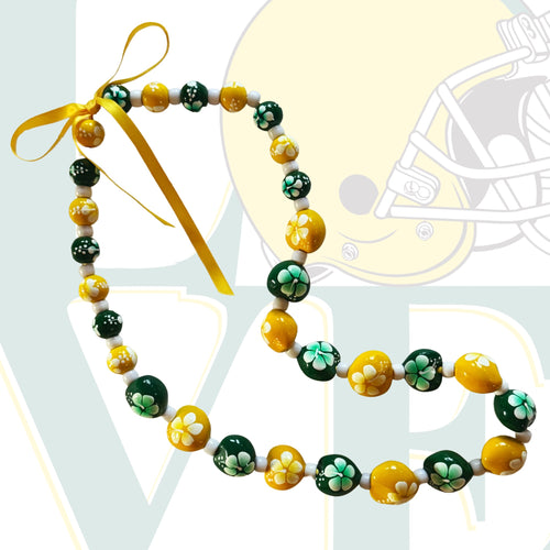Necklace with green and yellow beads on a white background